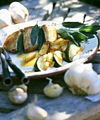 Chicken breast with sage and garlic on table out of doors