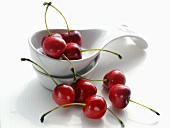 Several cherries with porcelain spoons