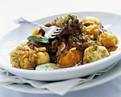 Beef and vegetable ragout with small bread dumplings