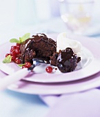 Chocolate pudding with redcurrants and cream