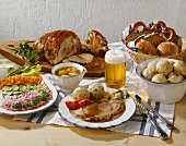 Soup, salad and roast pork with dumplings and beer