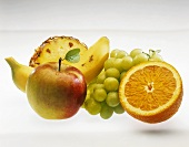 Fruit still life: apple, banana, grapes, pineapple, orange