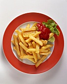 A plate of chips with ketchup