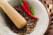 Szechuan pepper and chili peppers in mortar