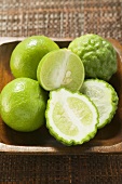 Kaffir limes and limes in wooden bowl