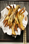 Deep-fried chicken feet on paper (Asia)