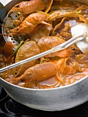 Crayfish stew in stew-pan on cooker