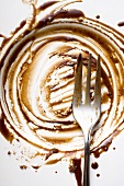 Plate with remains of chocolate sauce (close-up)