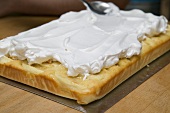 Spreading meringue smoothly on apple cake