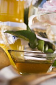 Honey in glass bowl in front of jars of honey