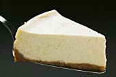 Slice of cheesecake on cake server