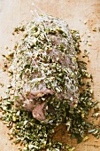 Raw pork roll with chopped herbs