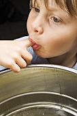 Child tasting honey