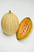 Whole and half of a cantaloupe melon