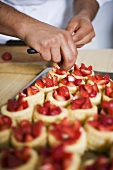 Filling vol-au-vent cases with strawberries
