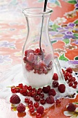 Fresh berries with sugar in carafe with spoon