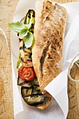 Grilled vegetables and basil in baguette