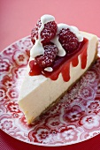 Piece of cheesecake with raspberries and cream