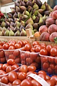 Tomatoes, figs and peaches at a market