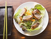 Lettuce with roast duck breast, vegetables, glass noodles (Asia)