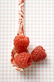 Raspberries on patterned spoon