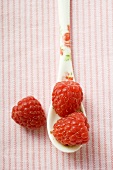 Raspberries on patterned spoon