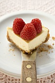 Piece of cheesecake with raspberries