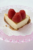 Piece of cheesecake with raspberries