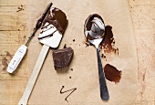 Piece of chocolate, remains of couverture, baking utensils