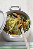 Savoy and carrot stew in pot