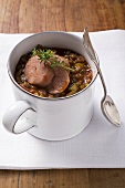 Lentil stew with sausage and thyme in mug