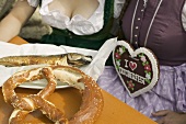 2 women with pretzel & Steckerlfisch (skewered fish), Oktoberfest