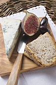 Piece of blue cheese, half a fig, olives and bread