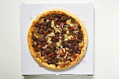 Mince and onion pizza with cheese on pizza box
