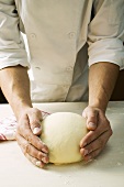 Forming pizza dough into a ball