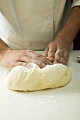 Kneading pizza dough