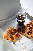 Slices of American-style pepperoni pizza with cola