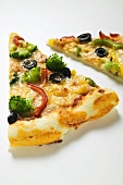 Two slices of American-style vegetable pizza