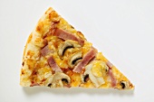 Slice of American-style ham and mushroom pizza