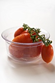 Plum tomatoes in a glass bowl