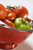 Various types of tomatoes in a colander