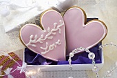 Two heart-shaped Christmas biscuits to give as a gift