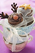 Chocolate muffins with Christmassy decorations in pile of cups