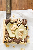 Piece of pear and chocolate tart with almonds