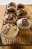 Several chocolate and vanilla muffins in paper cases