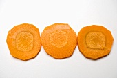 Three slices of carrot in a row