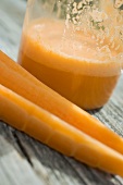 Glass of carrot juice and fresh carrots