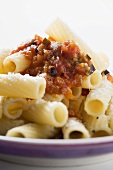 Rigatoni with tomato sauce, olives and Parmesan (close-up)