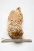 Rustic baguette on white cloth