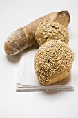 Three different wholemeal bread rolls on linen cloth